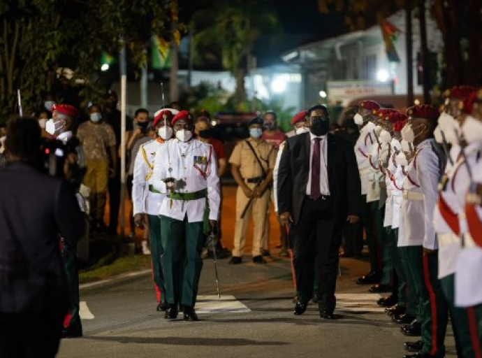 President Irfaan Ali inspects the Guard of Honour at the Flag Raising ceremony at Umana Yana Square, on Tuesday night.