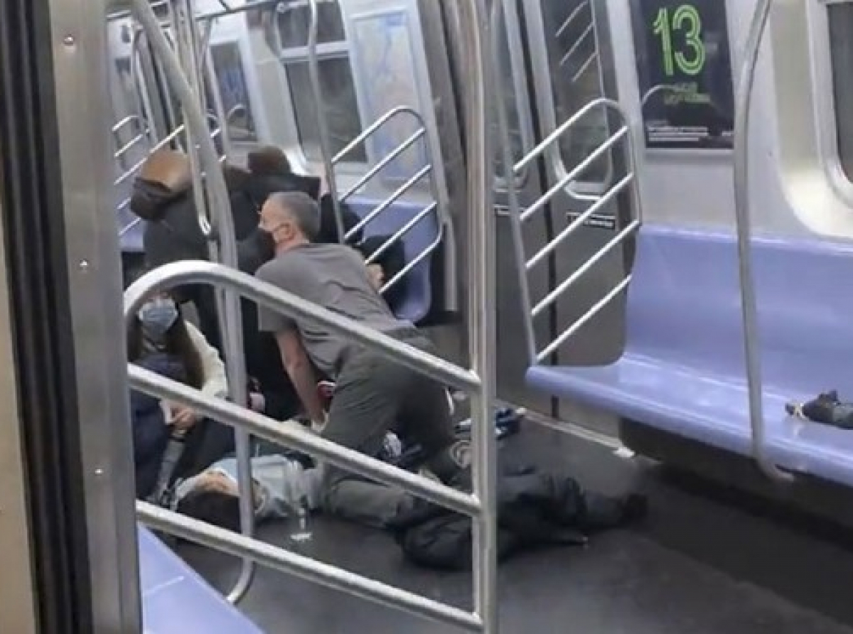 A subway rider is aided after being hurt when a gunman opened fire in a packed subway car during rush-hour in Brooklyn, New York on Tuesday, April 12, 2022. (Will B. Wylde/AP)