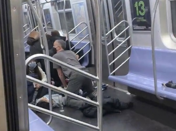 A subway rider is aided after being hurt when a gunman opened fire in a packed subway car during rush-hour in Brooklyn, New York on Tuesday, April 12, 2022. (Will B. Wylde/AP)