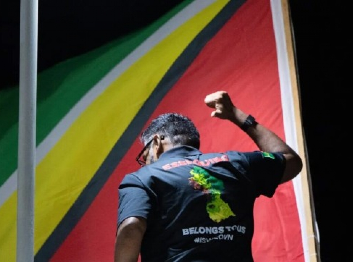 Presdident Irfaan Ali, points to his shirt which displays the message: Essequibo belongs to us.