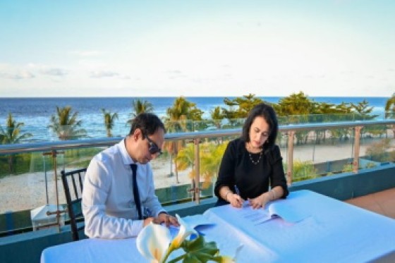 Amcham presidents Zulfikar Ally (left)and Toni Sirju-Ramnarine sign MoU