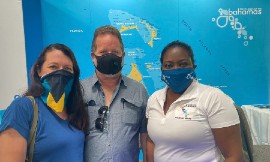 left to right is pilots Sue-Anne Pinder and Charles Albury of Abaco and Earnestine Moxyz, MOTA, Global Communications Manager who stopped by the MOTA's booth.