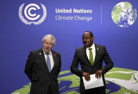 British Prime Minister Boris Johnson and Antigua and Barbuda Prime Minister Gaston Browne greet each other during COP26. (AP Photo)