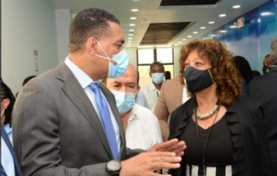 Prime Minister Andrew Holness engages a guest at the the opening of the IBEX BPO facility (JIS Photo)