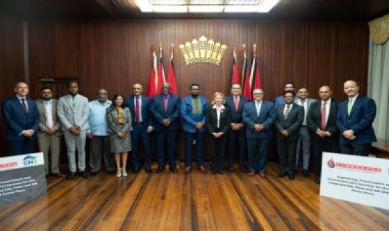 President Dr. Irfaan Ali (center) flanked by US Ambassador Sarah-Ann Lynch and other officials at the signing ceremony (DPI Photo)
