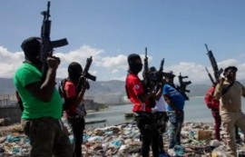 Armed gangs members in Haiti show off their weapons (File Photo)