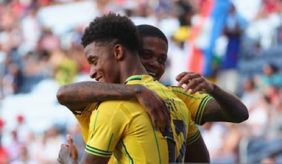 Everton’s Demarai Gray celebrates a goal with Aston Villa’s Leon Bailey on Wednesday night.