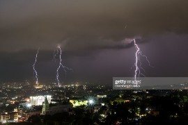 Lightning strikes during an electrical storm over Port-au-Prince on June 25, 2019. (Photo by CHANDAN KHANNA / AFP)