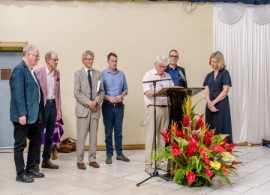 Laura Trevelyan (far right) and members of her family sign a formal apology to begin righting the wrongs of their ancestors who owned more than 1,000 slaves in the 19th Century. (UWI) photo)