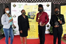 JCDC Director of Corporate Services Miss Elizabeth Smith (center-left) stands with the top three winners of the inaugural staging of the Fi Wi Short Film Competition, during a photo op at the competition’s award ceremony on Thursday. The top three winners are (left to right): Samantha Bent who won third place with her short film “Bad Timing”, Wesley Hylton who won first place with his short film “Too Much Massa”, and Naceve Blackstock who won second place with his short film “Consequence”.