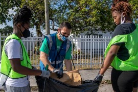 Volunteers and Michael J. Fernandez, Director of Solid Waste Management, team up to eliminate trash in the community.  (Photos by Armando Rodriguez / Miami-Dade County)