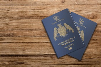 The Dominica passport is issued to citizens of the Commonwealth of Dominica for international travel,Dominica passport on a wooden background