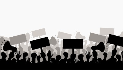 Silhouette of protesting crowd of people with raised hands and banners.