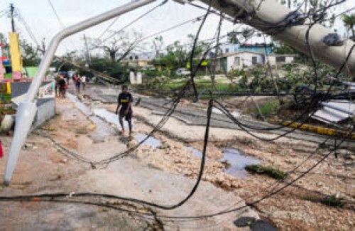 Residents walk through Santa Cruz, Jamaica, Wednesday, Oct. 29, 2025, after Hurricane Melissa passed. (AP Photo/Matias Delacroix)