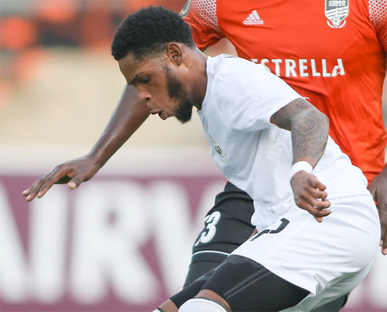 Ronaldo Webster (in white) of Cavalier SC in action in the Jamaican side’s match against Cibao FC during the Flow Concacaf Caribbean Club Championship. (Photo: CONCACAF)