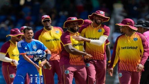 West Indies' Roston Chase, right, and Kyle Mayers embrace after defeating India for 4 runs in their first T20 cricket match at the Brian Lara Stadium in Tarouba, Trinidad and Tobago, Thursday, Aug. 3, 2023. (AP Photo/Ramon Espinosa)