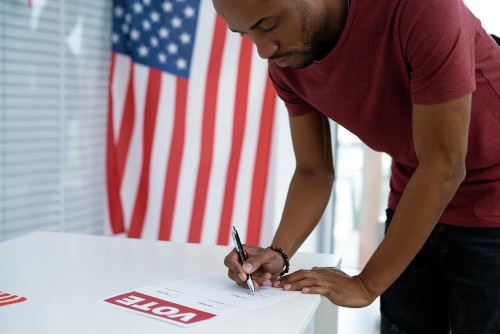 Black man voting in election ballot place