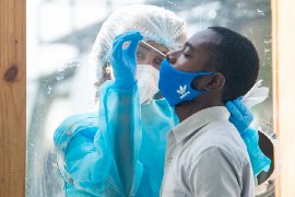 A healthcare worker administers a COVID-19 test. (Guyana DPI photo)