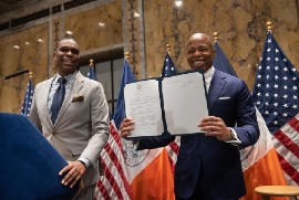astor Gilford Monrose, left, and New York City Mayor Eric Adams, right.