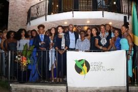 Jamaica’s Ambassador to the United States, Her Excellency Audrey Marks (sixth from left) and Chairman of the Jamaica Howard University Affinity Network (JHUAN), Don Christian (sixth from, right), are surrounded by Jamaican students attending Howard University, who have been awarded scholarships totaling US$102,000 by JHUAN. at the organization's 6th HUes of Blue fundraising event held on Saturday September 21.2024 at the Ambassador’s residence in Maryland. (Derrick Scott Photo)