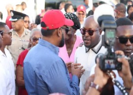 President Irfaan Ali with red cap, getting the endorsement of James Bond (with shades) on Thursday