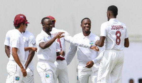 Fast bowler Alzarri Joseph (right) is congratulated by teammates after taking another wicket on Thursday. (Photo courtesy CWI Media)