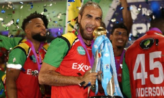 Guyana Amazon Warriors captain Imran Tahir celebrates with the Caribbean Premier League trophy on Sunday night. (Photo courtesy CPLT20/Getty Images) (via CMC)