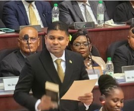 The leader of the We Invest in Nationhood (WIN), Azruddin Mohamed, being sworn in as a legislator on Monday