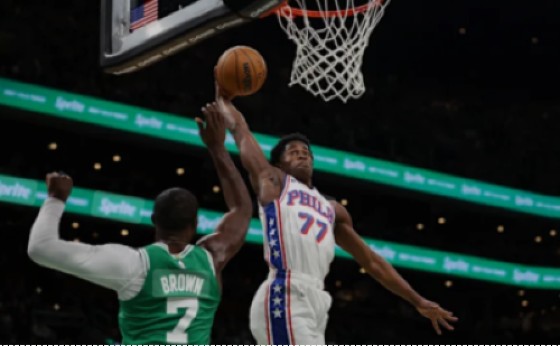 VJ Edgecombe of the Philadelphia 76ers (right) finishes strongly at the basket over Jaylen Brown of the Boston Celtics.