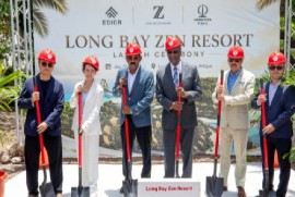 Developer Sophie Zhong (second from left) Prime Minister Gaston Browne (on her left) Governor General Sir Rodney Williams (centre) Tourism Minister Charles Fernandez (yellow suit) and two associates of Ms Zhong participated in the sod-turning ceremony at Long Bay .