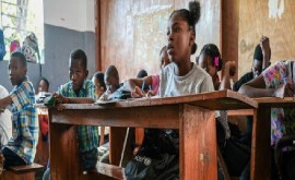 A young girl (centre) living in a displaced persons camp attends class in Haiti. (UNICEF/Herold Joseph Photo)