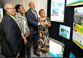 Special envoy for climate change, Professor Professor Dale Webber (left) joins other members of the Jamaica Government Adaptation Fund Programme (GOJ/AFP) in looking at the exhibition mounted at the end of the programme (JIS Photo)