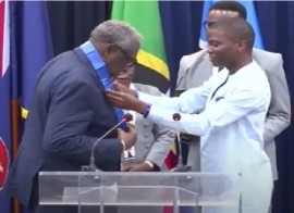 Former West Indies cricket captain, Sir Clive Lloyd being presented with the Order of Caribbean Community (OCC) by CARICOM Chairman, Grenada’s Prime Minister Dikon Mitchell on Sunday night (CMC Photo)
