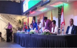 Members of the new proposed coalition government in Suriname sign the agreement on Sunday night