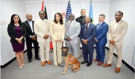 Trinidad and Tobago National Security Minister, Fitzgerald Hinds, (front row, third from left); US Ambassador to Trinidad and Tobago, Candace A. Bond, Lt. Col. Michael Jones, Executive Director, CARICOM IMPACS, Ambassador Todd D. Robinson, Assistant Secretary, US Bureau of International Narcotics and Law Enforcement Affairs and Michael P. Ben’Ary, Associate Deputy Attorney General of the US Department of Justice (DoJ) and US Coordinator for Caribbean Firearms Prosecutions (front row, second from right) with other participants of the meeting and the Belgian Malinois donated by the US.