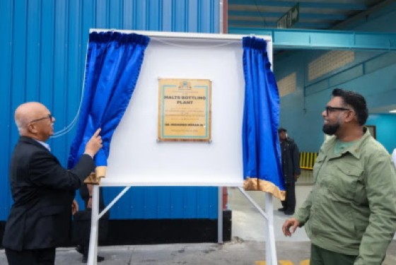 President Dr Mohamed Irfaan Ali (right) and Chairman of Banks DIH, Clifford Reis, unveil the commemorative plaque at Sunday’s ceremony