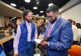 President Dr Irfaan Ali signing copies of his book
