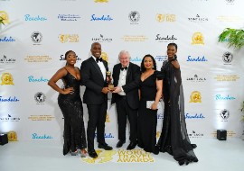 Sheldon Keens-Douglas (left), Resort Manager at Spice Island Beach Resort, is congratulated by World Travel Awards Founder Graham Cooke at the Caribbean & North America Gala Ceremony in St. Lucia.