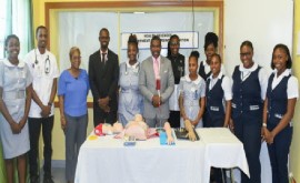Prime Minister Dr. Terrance Drew (center) flanked by members of the nursing profession