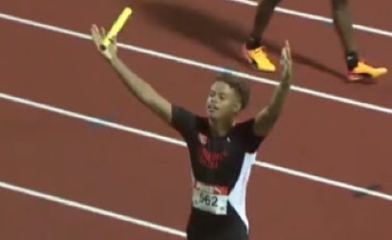 Trinidadian Dylan Woodruffe celebrates with the Trinidadian fans after taking his team to victory in the boys Under-20 sprint relay.