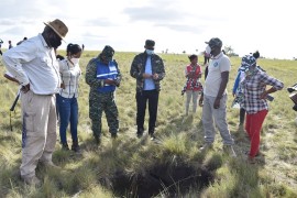 An assessment team, including Minister of Home Affairs Robeson Benn (first left) and CDC’s Lieutenant Colonel Kester Craig (second from right) observe a hole created by the earthquake.