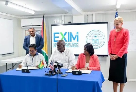 Senior Finance Minister Dr. Ashni Singh (sitting, left) and United States EXIM Bank’s President and Chair Reta Jo Lewis (sitting, right) sign the term sheet on Friday. Overseeing the process was Prime Minister Brigadier Mark Philips (centre). (DPI)