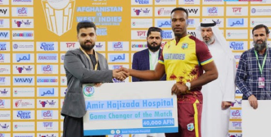 Matthew Forde (centre) accepts his Game Changer of the Match award for his performance in the final T20I against Afghanistan