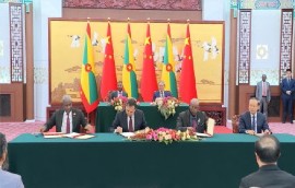 China and Grenada officials signing the various cooperation agreements in Beijing.