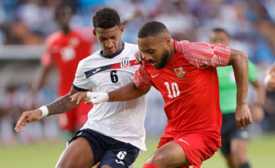 Matthias Phaeton (right) holds off Cuba’s Yosel Piedra during Guadeloupe win on Saturday.