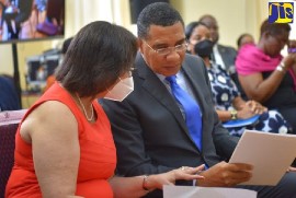 Prime Minister, the Most Hon. Andrew Holness (right), speaks with Chairman, National Commission on Violence Prevention, Professor Maureen Samms-Vaughan, at the public presentation of the Commission at the Banquet Hall, Jamaica House, on August 11. (Photo courtesy of JIS/YHOMO HUTCHINSON)