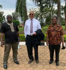 With masks in tow, Dr. Jonathan Weaver (center) stands in Rwanda with Edouard Ndayisaba,CEO, DGrid Energy (left) and Dr. Jean Mfizi, an epidemiologist and deputy vice chancellor for public affairs, Adventist University of Central Africa.