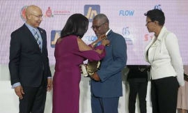 Governor-General, His Excellency, the Most Hon. Sir Patrick Allen looks on as Her Excellency,  Lady Allen, wife of the Governor-General of Jamaica, pins Wayne Golding, Governor-General’s Achievement Award recipient for the Diaspora Over 35 Age Group, USA. Also sharing the occasion is Jamaica’s Ambassador to the United States, Her Excellency Audrey Marks.