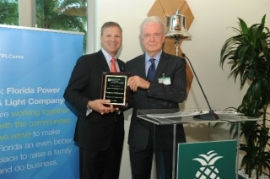  FPL President and CEO Eric Silagy accepts a plaque from Baptist Health South Florida President and CEO Brian E. Keeley. 