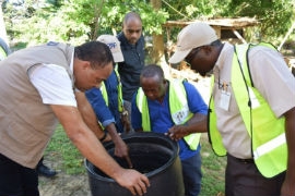Minister of Health and Wellness, Dr. Christopher Tufton (left) and Vector Control Coordinator at the St. Elizabeth Health Department, Michael Myles (right) along with team members from the St. Elizabeth Health Department inspect a drum of water at a property in St. Elizabeth earlier this year. (